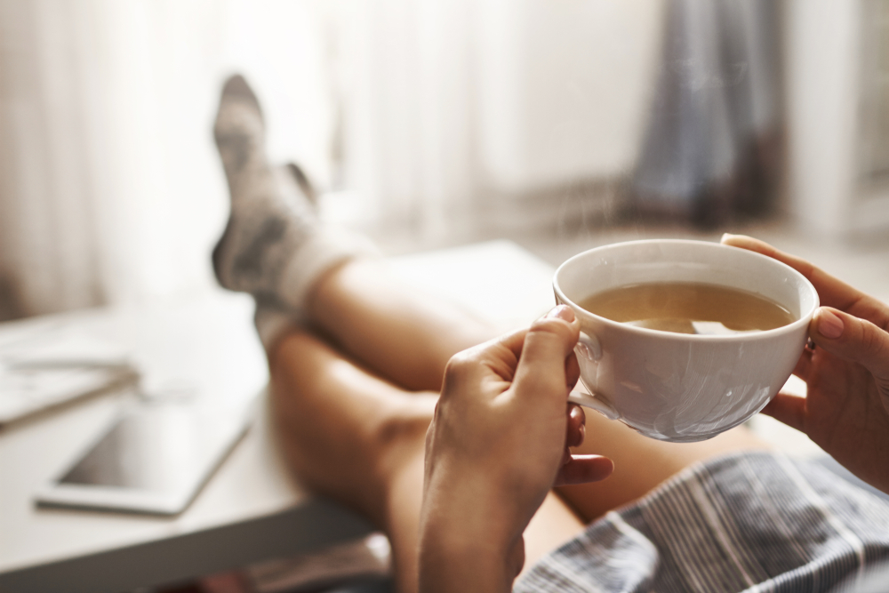 person resting with a cup of tea