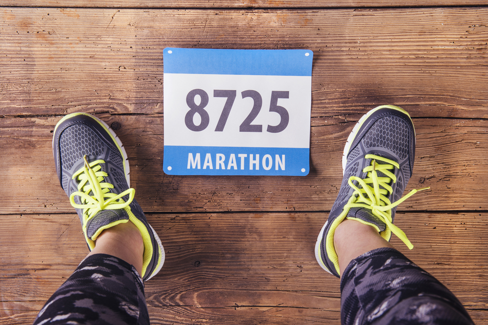 running trainers and marathon number sign